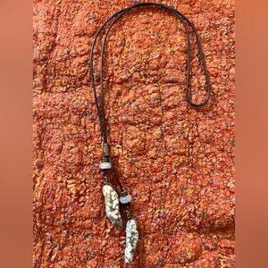 On trend lariat style leather necklace with stone pendants.